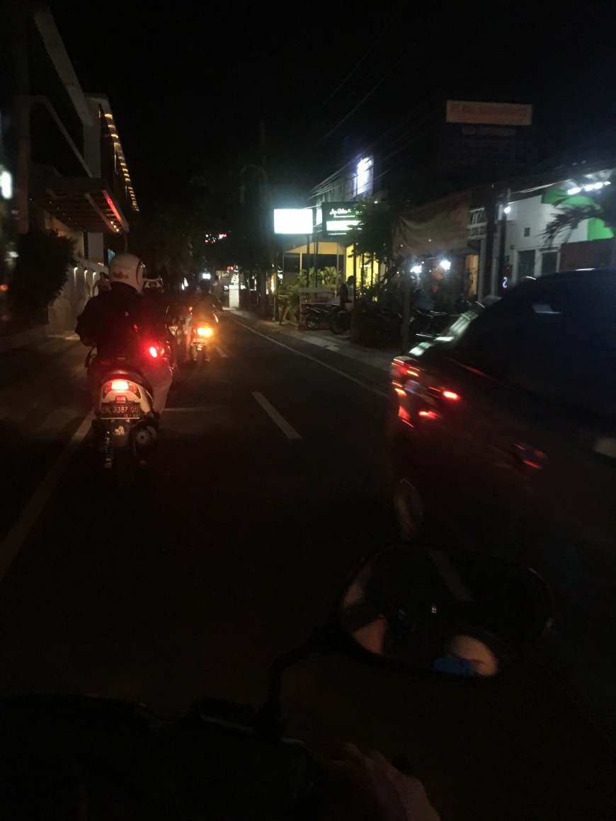 Riding a scooter at night in Bali