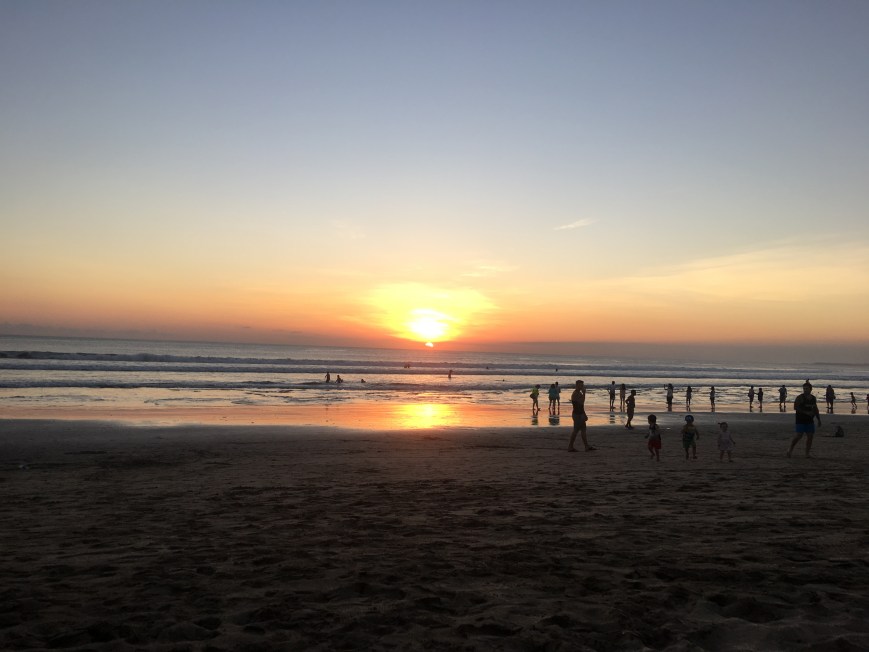 Listening to locals play guitar while watching sunset over the beach in Bali