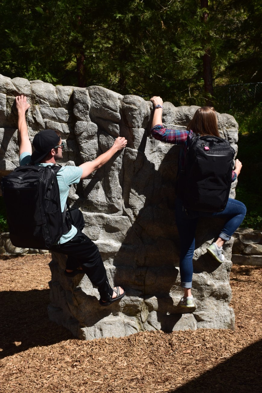 Climbing up a rock wall with our Tortuga Backpacks on