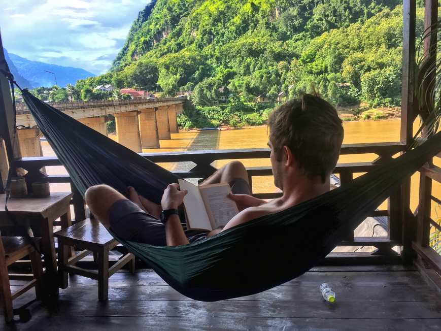 Enjoying some reading by the river in Nong Khiaw, Laos