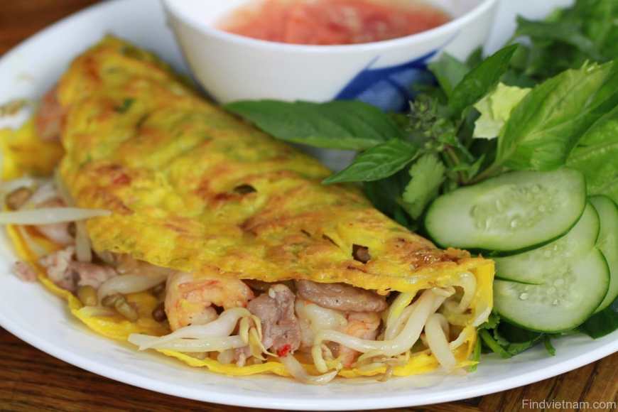 Vietnam's sizling moon crepe known as Banh Xeo stuffed with