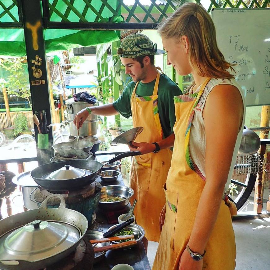 Travel couple enjoying taking a local cooking class in Inle Lake Myanmar