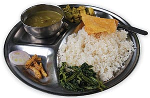 Nepal's staple Dal Bhat dish served on a metal plate