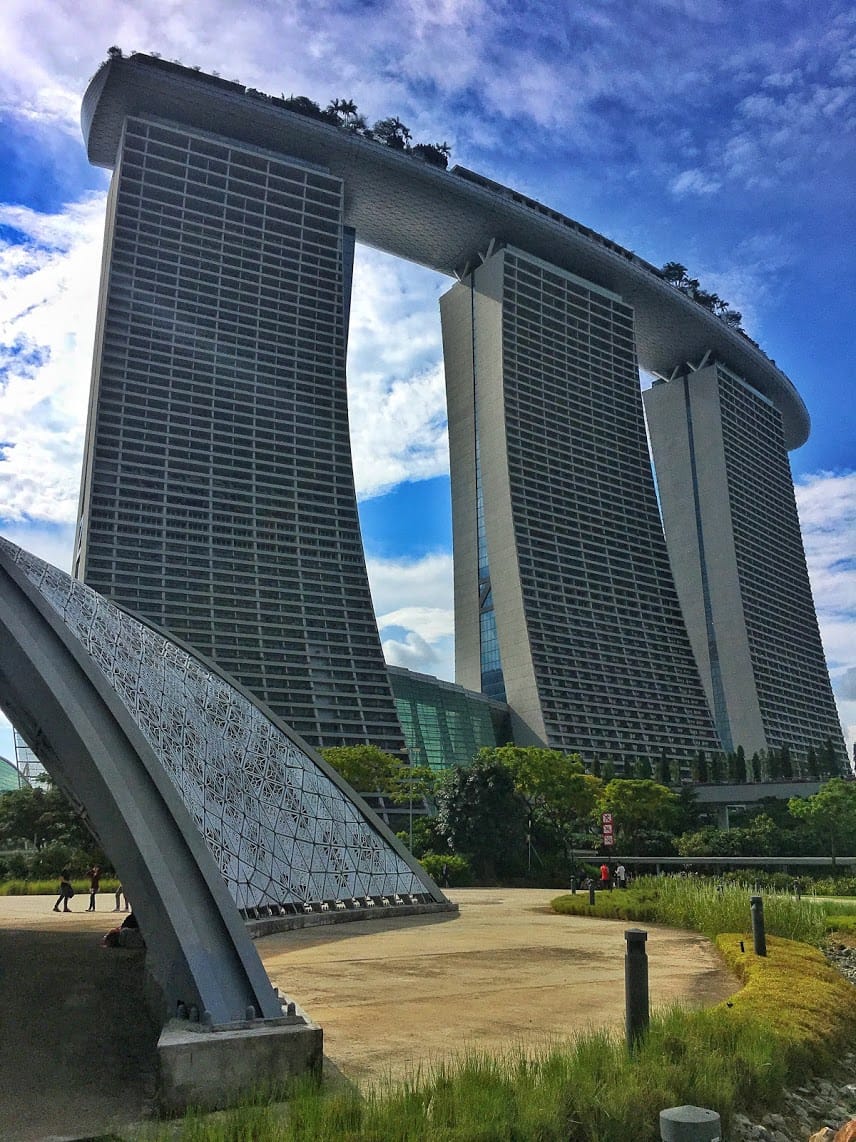 View of Marina Bay Sans in the distance over Gardens by the bay with bright blue skies