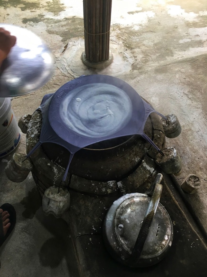 Traditional method of making rice paper with fabric stretched over pot of boiling water